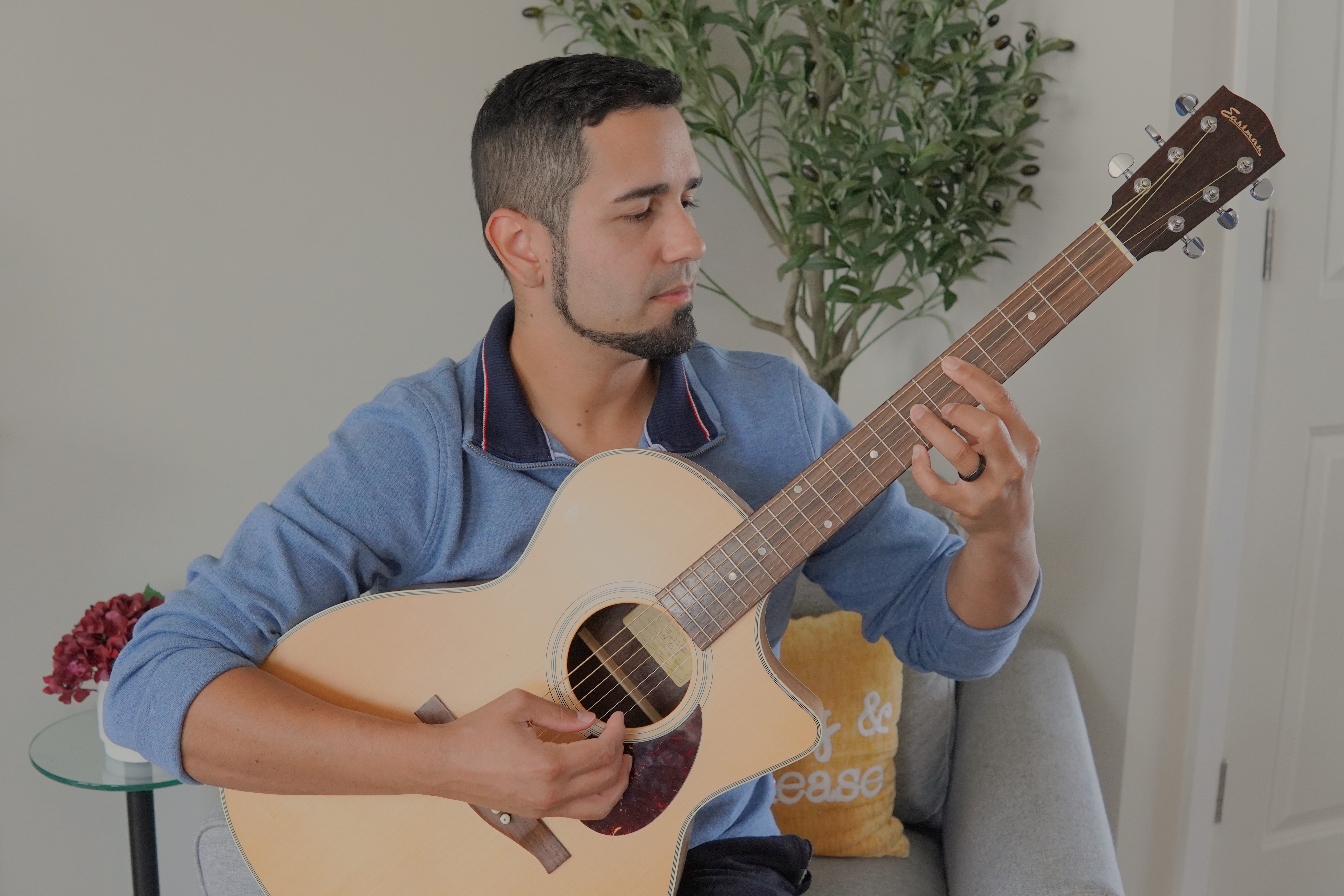 Jason Trinidad playing an acoustic gutiar 